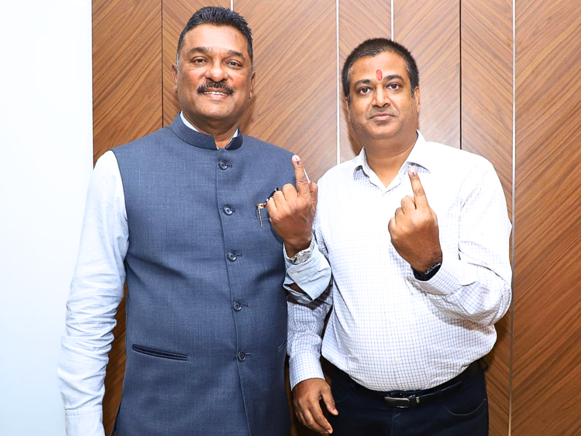 Shiv Sena leader Partap Sarnaik is standing with Sunil Keshary, both proudly displaying their inked fingers to the camera. The image captures a moment of civic engagement, as both individuals have just cast their votes in a recent election.